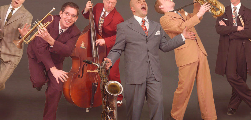 Ein Foto von den Jive Sharks, die mit ihren Instrumenten in Anzügen posieren